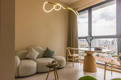 a living room with a couch and a large window at Designer Suites 2BR Apartment in Penang near George Town Self Check-In WiFi Partial Seaview in Jelutong