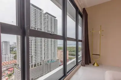 a room with large windows with a view of a city at Designer Suites 2BR Apartment in Penang near George Town Self Check-In WiFi Partial Seaview in Jelutong