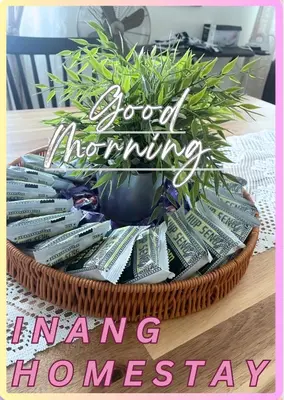 a basket filled with money on a table with a plant at Inang Homestay in Teluk Intan