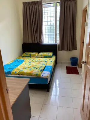 a bedroom with a bed in a room with a window at Highlands Double Story House in Tanah Rata