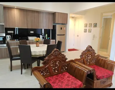 a kitchen and dining room with a table and chairs at By The Sea Beach Front and Seaview Apartment 2 in Batu Ferringhi