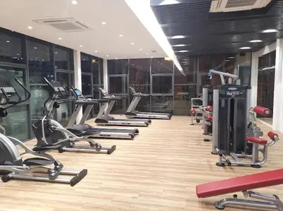 a gym with a row of exercise bikes and treadmills at Sweet Homestay Meritus by Moowin in Perai