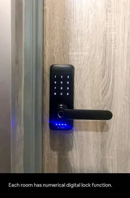a black remote control attached to a door at Triple Room in King Queen Single Bukit Mertajam Alma in Bukit Mertajam