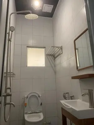 a bathroom with a toilet and a sink at Triple Room in King Queen Single Bukit Mertajam Alma in Bukit Mertajam