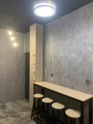 a kitchen with a counter with stools in a room at Triple Room in King Queen Single Bukit Mertajam Alma in Bukit Mertajam
