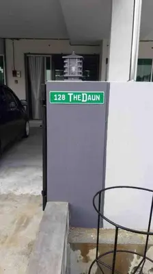 a machine in a garage with a table and a chair at Bota TheDaun Homestay Taman Indera in Kampung Bota Kiri