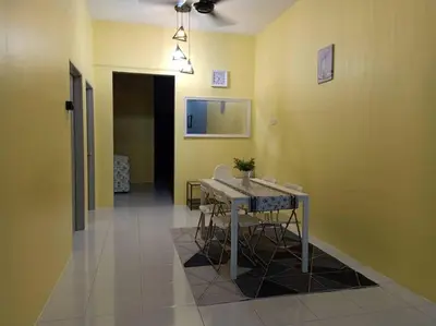 a hallway with a table and chairs in a room at Bota TheDaun Homestay Taman Indera in Kampung Bota Kiri