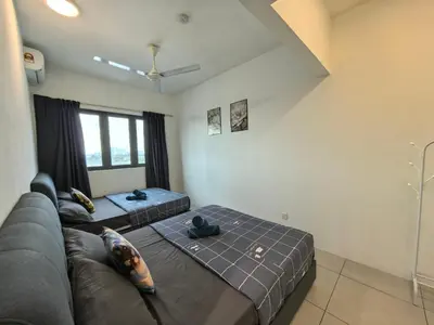 a living room with a couch and a bed at Meritus Family Comfy Deluxe Home in Perai