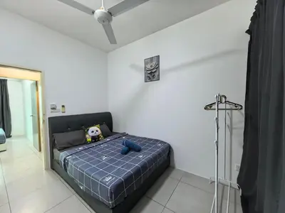 a bedroom with a bed with a teddy bear on it at Meritus Family Comfy Deluxe Home in Perai