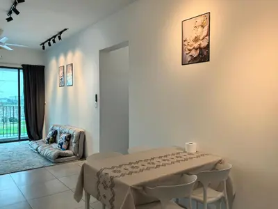 a dining room with a table and chairs and a window at Meritus Family Comfy Deluxe Home in Perai
