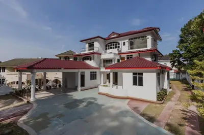 a large white house with red roof at Villa55 w Private swimming pool BBQ Pool table 25pax in Bayan Lepas