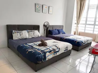 a bedroom with two beds and a fan at Irdina HomestayMuslim's at Emerald Avenue Brinchang Centrum in Brinchang