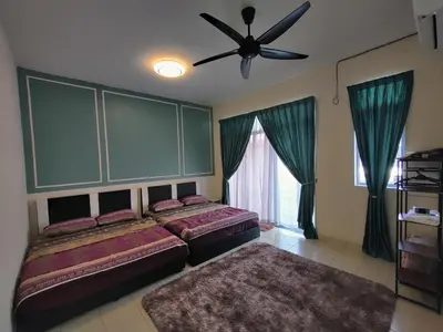a bedroom with two beds and a ceiling fan at Homestay Adleya in Bagan Serai