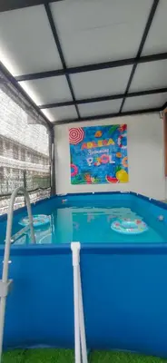 a water play area with a pool in a building at Homestay Adleya in Bagan Serai