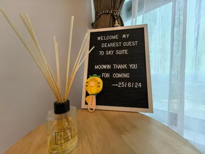 a sign sitting on top of a table with a vase at Sky Suite Meritus Residence in Perai in Perai