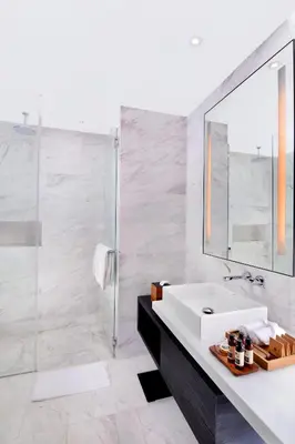 a white bathroom with a sink and a mirror at G Hotel Kelawai in George Town