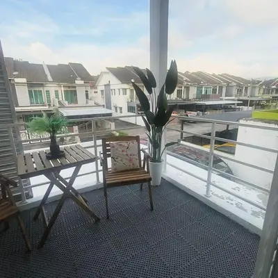 a balcony with a bench and a table and a plant at Taiping Holiday Home 2 in Taiping