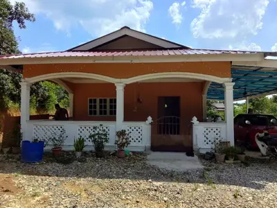 a small house with a porch and a car parked at Homestay Abah At in Baling