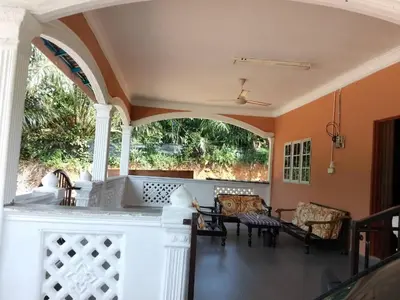 a porch with an archway and a table and chairs at Homestay Abah At in Baling
