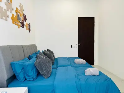a blue bed with pillows on top of it at BM\u5927\u5c71\u811a Double Storey Terrace Autocity Alma Aeon Jusco Nearby in Bukit Mertajam