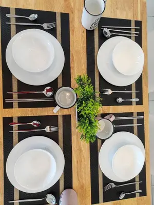 an overhead view of a table with white plates and silverware at 2 Rooms Apartment, 4 to 5 pax at Urban Suites by SuperStay in Jelutong