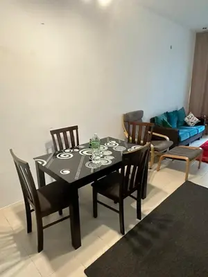 a dining room with a table with chairs and a couch at AYAAN FAMILY HOMESTAY FREE WiFi in Tanah Rata