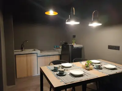 a kitchen with a table with plates and bowls on it at Cozy 2-Bedroom Apartment in Air Itam, Perfect for Family & Friends Getaway in Ayer Itam