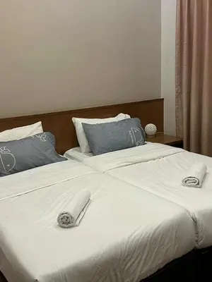 a bed with two slippers on top of it at Nova \u5bb6\u5ead\u623f in Brinchang