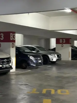 two cars are parked in a parking garage at Nova \u5bb6\u5ead\u623f in Brinchang