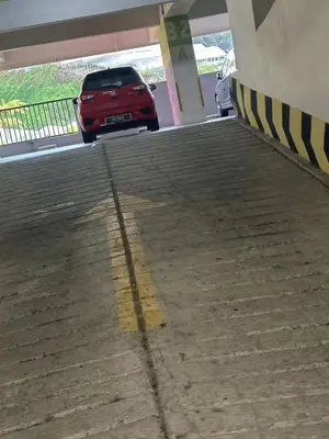 a red car parked in a parking lot at Nova \u5bb6\u5ead\u623f in Brinchang