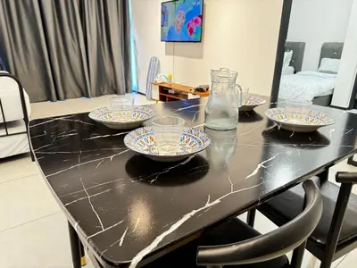 a black table with four bowls on top of it at b29 Condo In Georgetown Familystay 3BR-10PAX in Jelutong