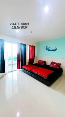 a bed in a room with a sign on the wall at D'Marina 2 HOMESTAY LUMUT MANJUNG in Lumut