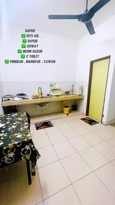 a room with a desk and a table in it at SS MANJUNG HomeSTAY in Seri Manjung