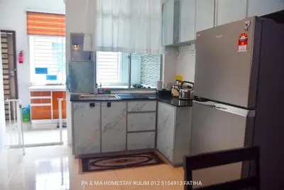 a kitchen with a refrigerator and a sink at Pa&Ma HomeStay Kulim II 3R2B fully aircond wifi netflix in Kulim