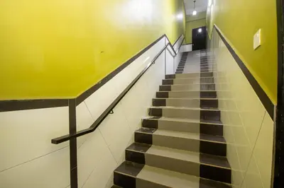 a staircase in a building with a yellow wall at JQ Happy Lumut Hotel in Lumut