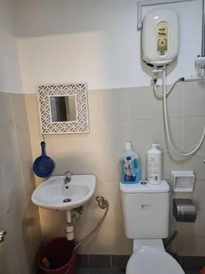 a small bathroom with a toilet and a sink at 5 Lot 10 Pangkor Leisure Beach Studio in Pangkor