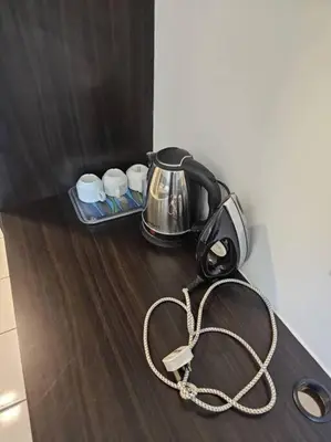 a tea kettle with a cord on a table at 5 Lot 10 Pangkor Leisure Beach Studio in Pangkor