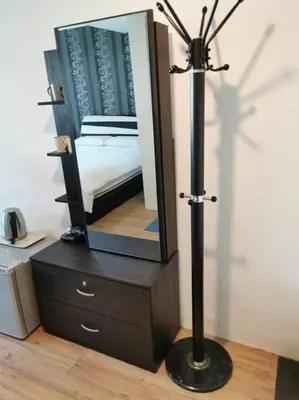 a mirror on top of a dresser with a lamp at C 23 Lot 10 Pangkor Leisure Beach Studio in Pangkor