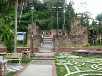 a stone building with a maze in the grass at 39 Lot 10 Pangkor Leisure Beach Studio in Pangkor