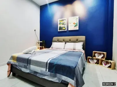 a bedroom with a bed with a blue wall at 11pax5br Modern 5mins Ipoh Town wPoolTable in Ipoh
