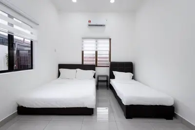two beds in a room with white walls at Dream - Autumn at Pinji Ipoh Town in Ipoh