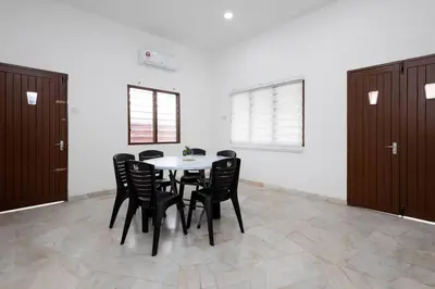 a dining room with a table and black chairs at Dream - Autumn at Pinji Ipoh Town in Ipoh