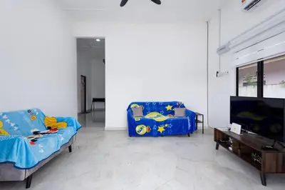 a living room with two couches and a flat screen tv at Dream - Autumn at Pinji Ipoh Town in Ipoh