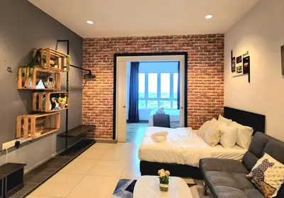 a living room with a bed and a brick wall at Ipoh City Centre 八角楼 OCTAGON Homestay - 2 mins walking to famous food & 15 mins to Old Town Ipoh by Happy Homestay in Ipoh