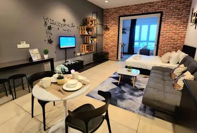 a living room with a couch and a table at Ipoh City Centre 八角楼 OCTAGON Homestay - 2 mins walking to famous food & 15 mins to Old Town Ipoh by Happy Homestay in Ipoh