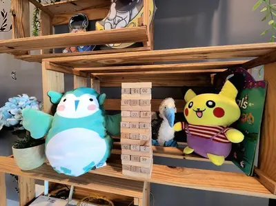 a shelf with various stuffed animals on it at Ipoh City Centre 八角楼 OCTAGON Homestay - 2 mins walking to famous food & 15 mins to Old Town Ipoh by Happy Homestay in Ipoh