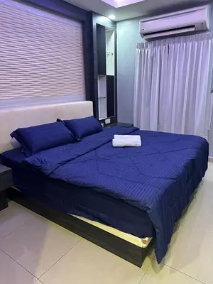 a bedroom with a large blue bed with blue pillows at Double Storey House at Raja Uda with 3 rooms in Butterworth