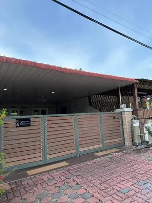 a fence in front of a house with a sign on it at Double Storey House at Raja Uda with 3 rooms in Butterworth