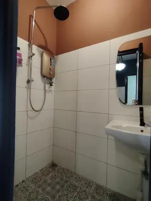 a bathroom with a sink and a mirror at Georgetown Guest House 37 in George Town