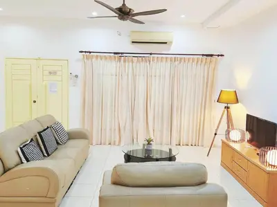 a living room with a couch and a tv at 10min to IPOH TOWN gunung lang 4br4bath 14 pax in Ipoh